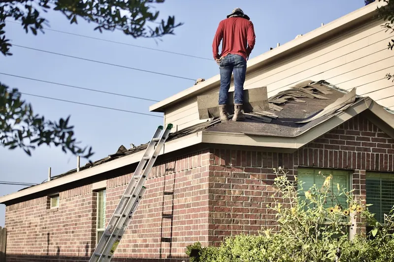 Professional roofer working on a residential roof in Fouts Corner
